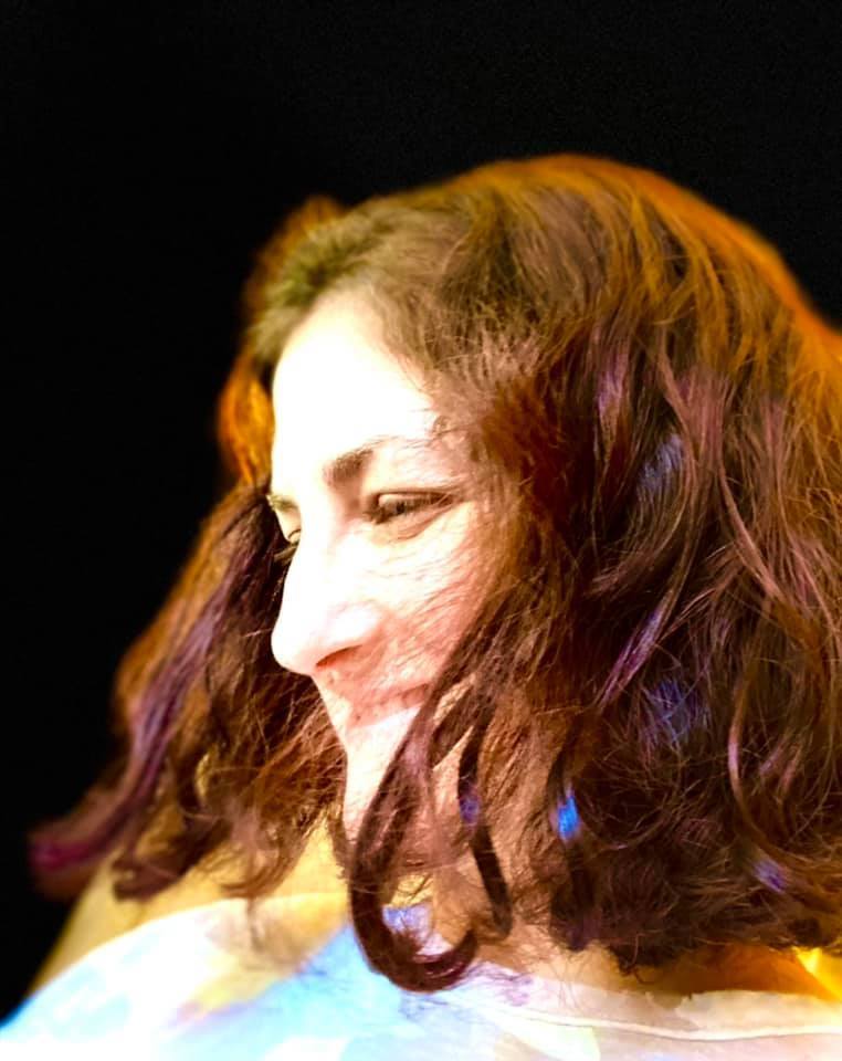 Amy Cross performing under stage lights